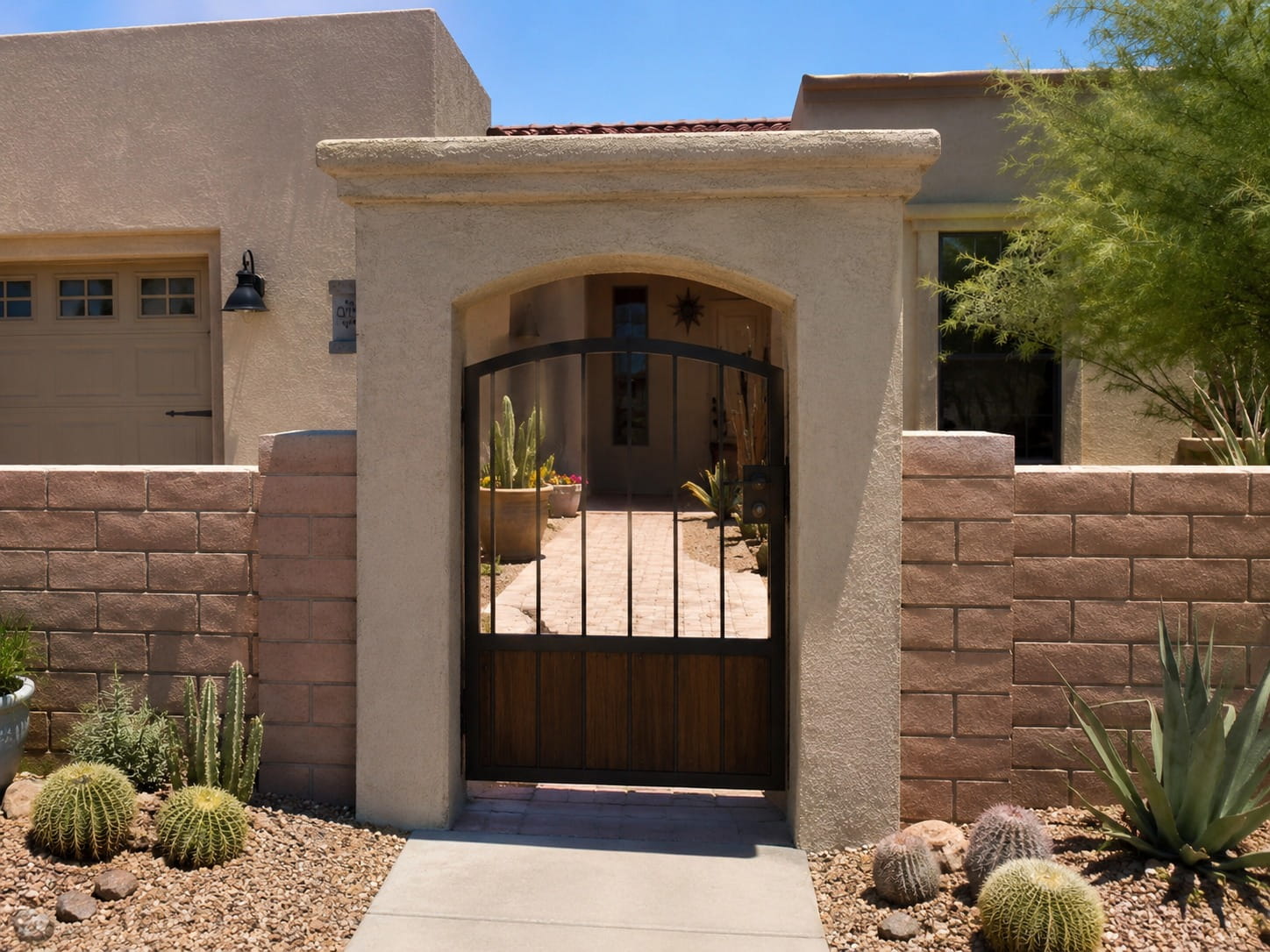 Decorative brick block wall and gated entry at a Tucson home